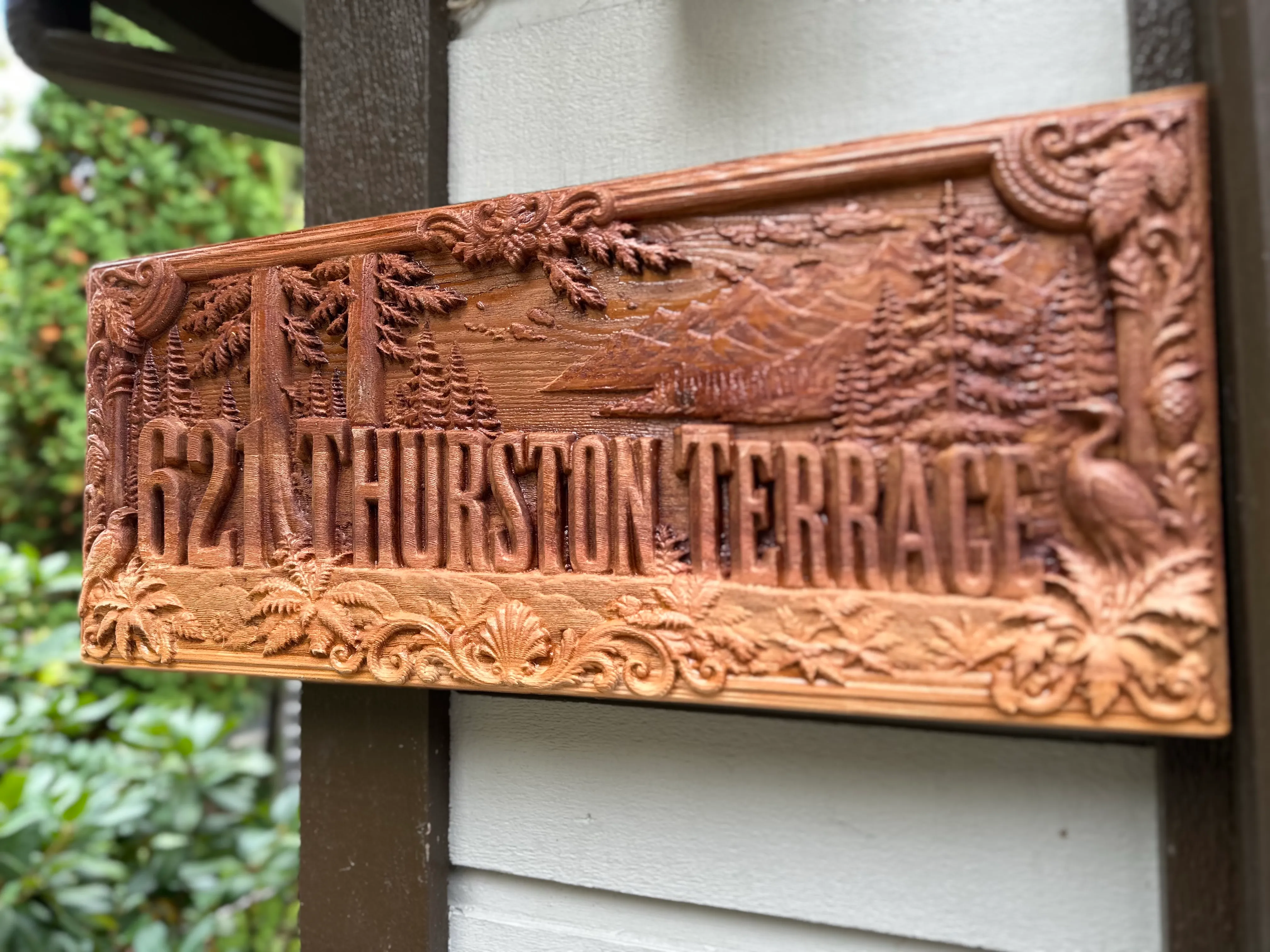 Pacific Northwest sign with cedars and a heron